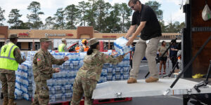 U.S. Army Soldiers with the Augusta-based 878th Engineer Battalion, 648th Maneuver Enhancement Brigade, Georgia Army National Guard, partner with Georgia State Defense Force personnel to unload cases of water during a point of distribution (POD) mission in Augusta, Georgia, Sept. 30, 2024. The Georgia National Guard has mobilized to provide response and recovery support to areas in the state impacted by Hurricane Helene. At the direction of the Governor and through The Georgia Emergency Management and Homeland Security Agency (GEMA/HS), the Georgia National Guard will continue to partner local, state, and federal entities in this effort. (U.S. Army National Guard photo by Spc. Ayanna Tillman)