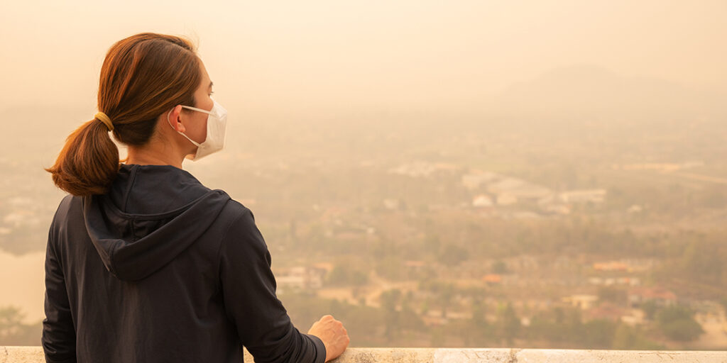 Asian woman wearing an N95 mask for protect bad air pollution.