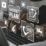 floating emergency concept buttons above laptop keyboard, hand on keyboard